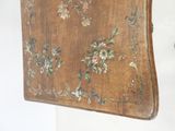 an old wooden table with a floral design on it