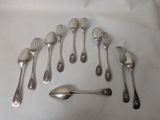 a lot of silver spoons and spoons on a table