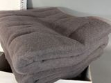 a box with a blanket and a pair of shoes in it