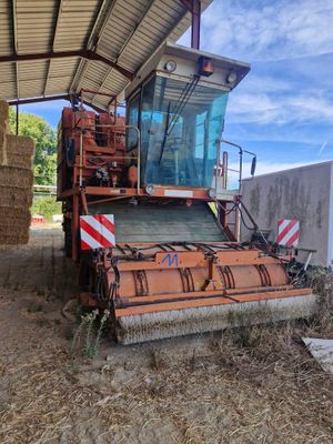 un tracteur garé à côté d'une balle de foin