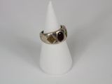 a close up of a ring on a cone on a white surface