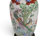 a large vase with a dragon on it on a stand
