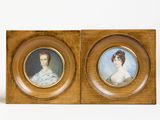 two framed portraits of a woman and a man in a wood frame
