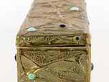 an antique brass box with blue and green stones on it