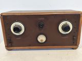 an old radio sitting on top of a white table next to a wall