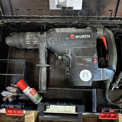 a drill in a tool box with other tools in it