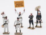 several figurines of men in uniforms holding signs on wooden bases