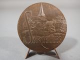 an image of a bronze coin with a castle in the background