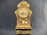 a clock that is sitting on a stand on a black background
