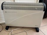 a heater that is sitting on the floor next to a wall