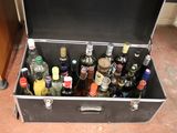 a trunk full of bottles of alcohol on the floor