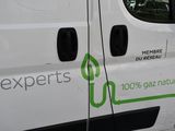a white van with a green sticker on the side of it