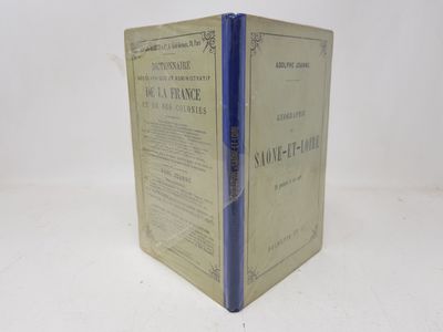 an old book with a blue cover sitting on top of a white table