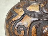a close up of a decorative vase on a table