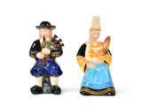two figurines of a man and a woman standing next to each other