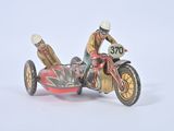a figurine of a man riding a motorcycle on a white surface