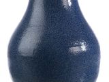 a blue vase that is sitting on a table