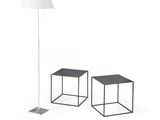 two black tables with a white lamp on top of them