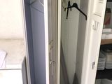 a closet with a door open in a small room