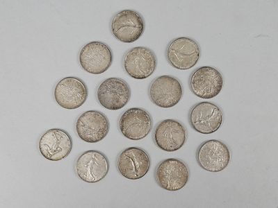 a lot of coins arranged in a circle on a white surface