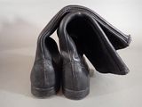 a pair of black shoes that are next to a wallet