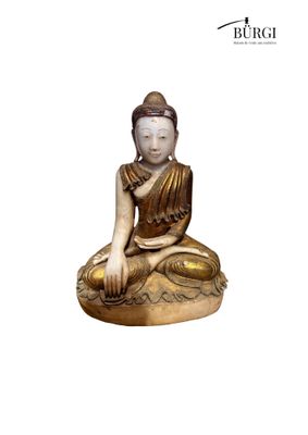 statue of a seated buddha sitting on a rock on a white background