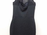 the dress is black and has a bow at the neck