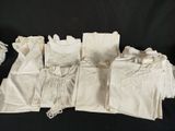 a lot of white cloths that are on a table