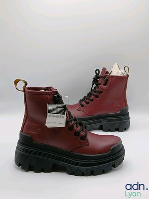 red leather boots with black soles and rubber outs