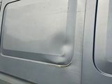 a silver van that is parked on the side of the road