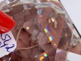 a person holding a piece of glass with a sticker on it