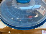 a blue plastic lid on top of a cardboard box