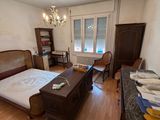 an image of a bedroom with a bed and a desk in it