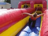 a young boy that is on a inflatable water slide