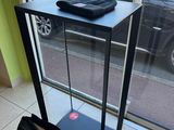 a bag sitting on the floor in front of a glass display case