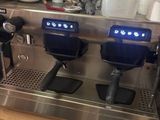 two coffee machines that are sitting on a counter