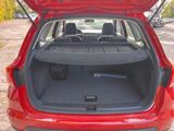 a red car with its trunk open in a parking lot
