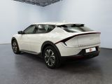 the rear end of a white car parked in a showroom