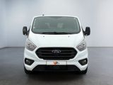 the front view of a white ford transit van parked in a room