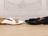two pairs of black and white shoes with tassels on them