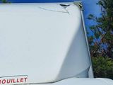 a white van with a red sticker on the hood