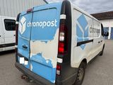 a van parked in a parking lot with other vans in the background