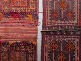 three small rugs hanging on a wall next to each other