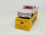a pink toy car sitting on top of a yellow box