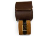 brown and black leather case with a gold buckle on a white background