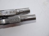 two pens that are sitting on top of a table