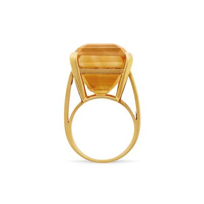 a close up of a gold ring with a stone in the middle