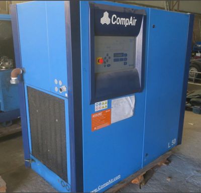 a close up of a blue machine in a warehouse with other machines