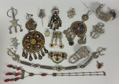 many different types of jewelry displayed on a white surface