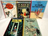 four children ' s books are lined up on a white surface